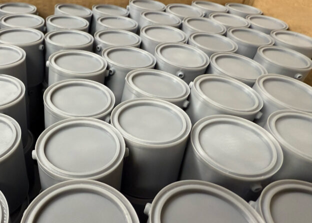 Precision mini paint tins 3D-printed at scale using the rapid prototyping and small-batch services from 3D Printing Leeds.